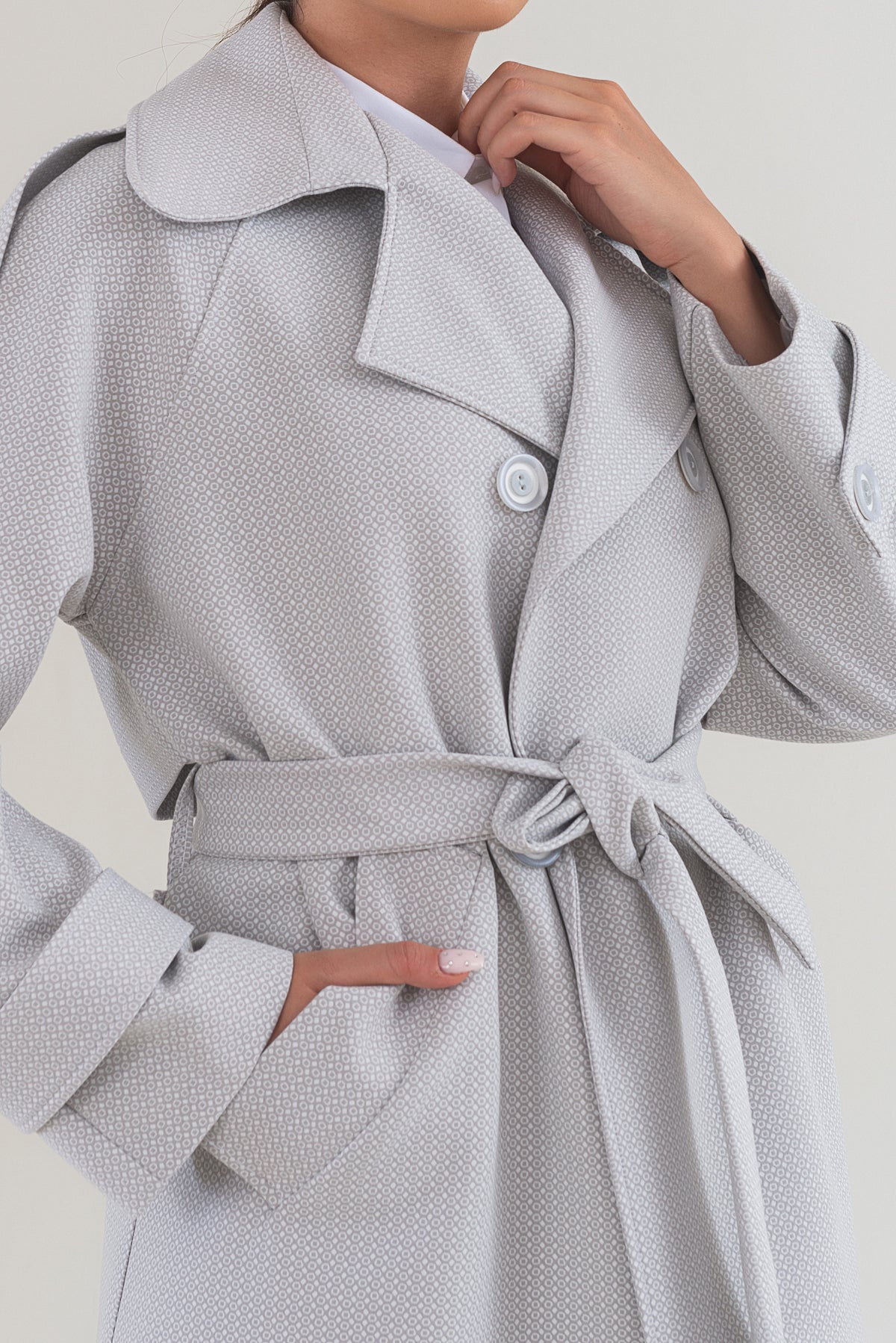 Gray coat with a belt on a plain background